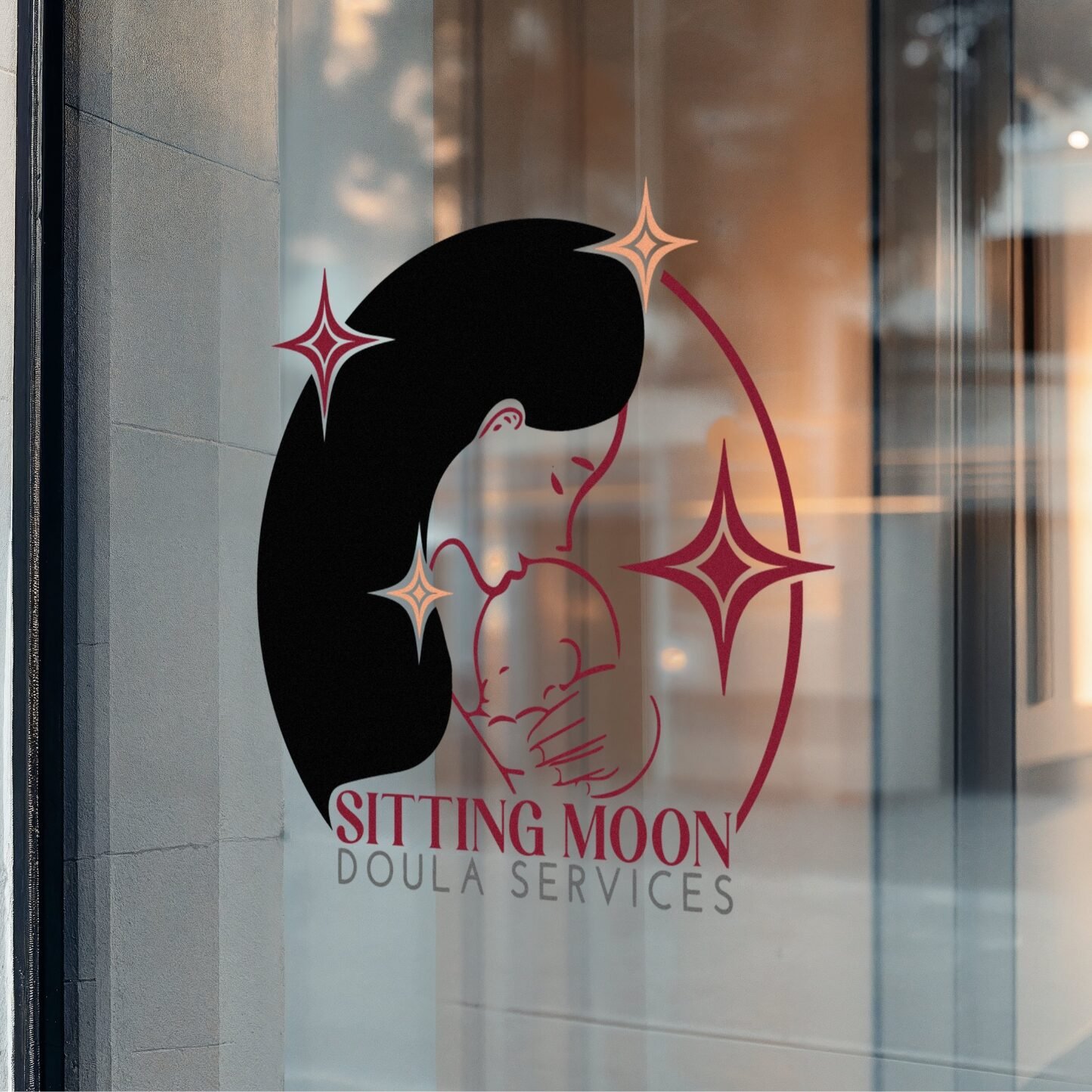 A mock up of the Sitting Moon Doula logo on a window