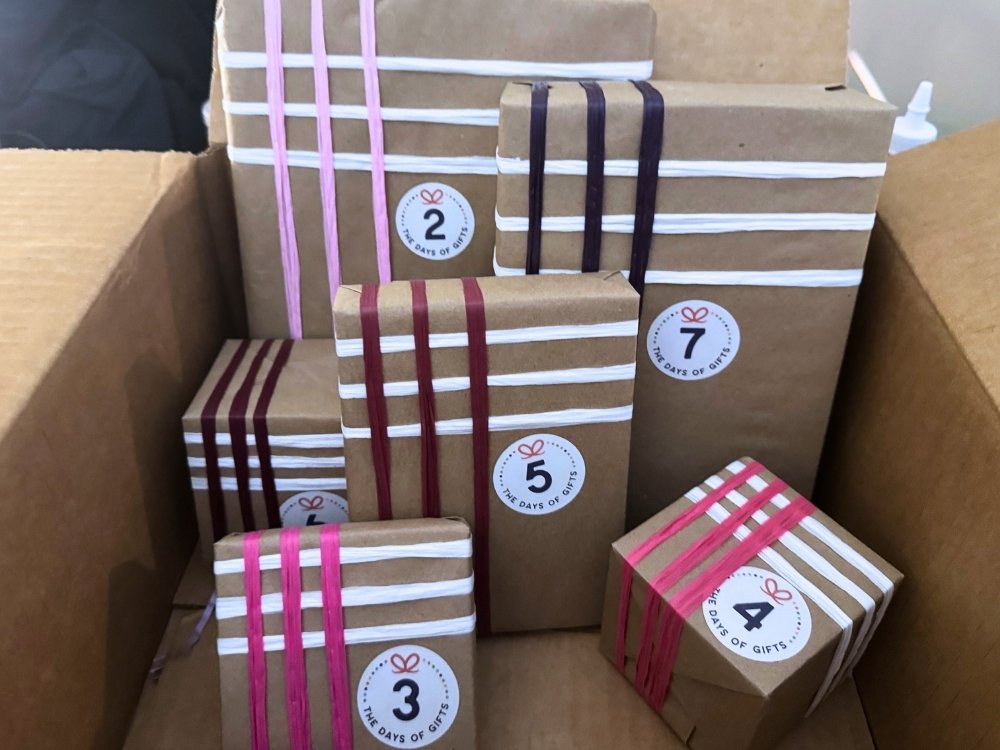 A box of wrapped presents from the 7 Days of Gifts, a fun surprise for a digital retreat.