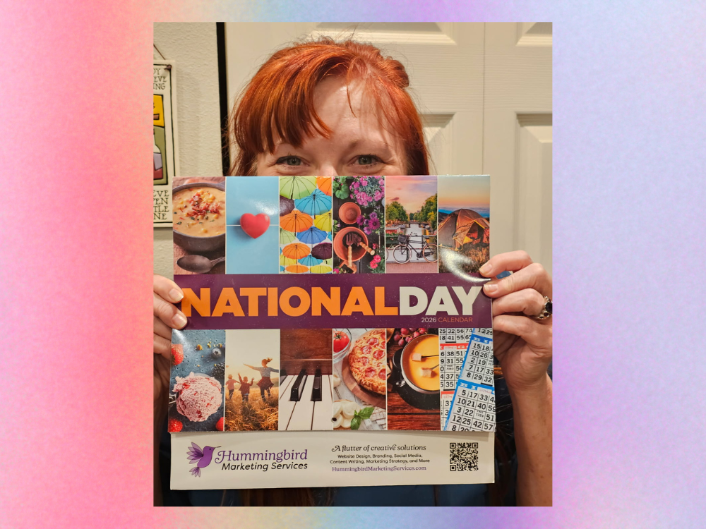 Andi Lucas with our annual National Day calendars for 2026 - a tradition we've been gifting our clients since our start!