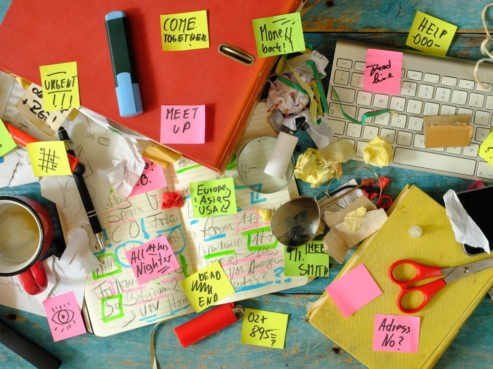 Free spirits tend to thrive with a lack of "typical" structure, depicted here by a messy desk with lots of sticky notes. A tip from the blog, How to Avoid Burnout, Writer’s Block, and Creative Slumps by Hummingbird Marketing Services.