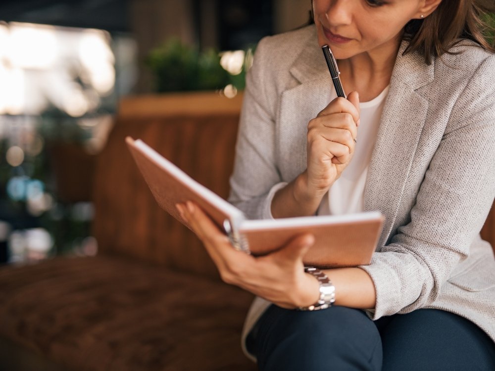 A woman reflecting on the best routine for her work style. A tip from the blog, How to Avoid Burnout, Writer’s Block, and Creative Slumps by Hummingbird Marketing Services.