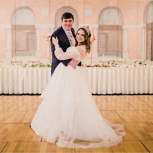 Web and Graphic Designer Elizabeth Phillips and her husband dancing to their custom Disney love song at their wedding.