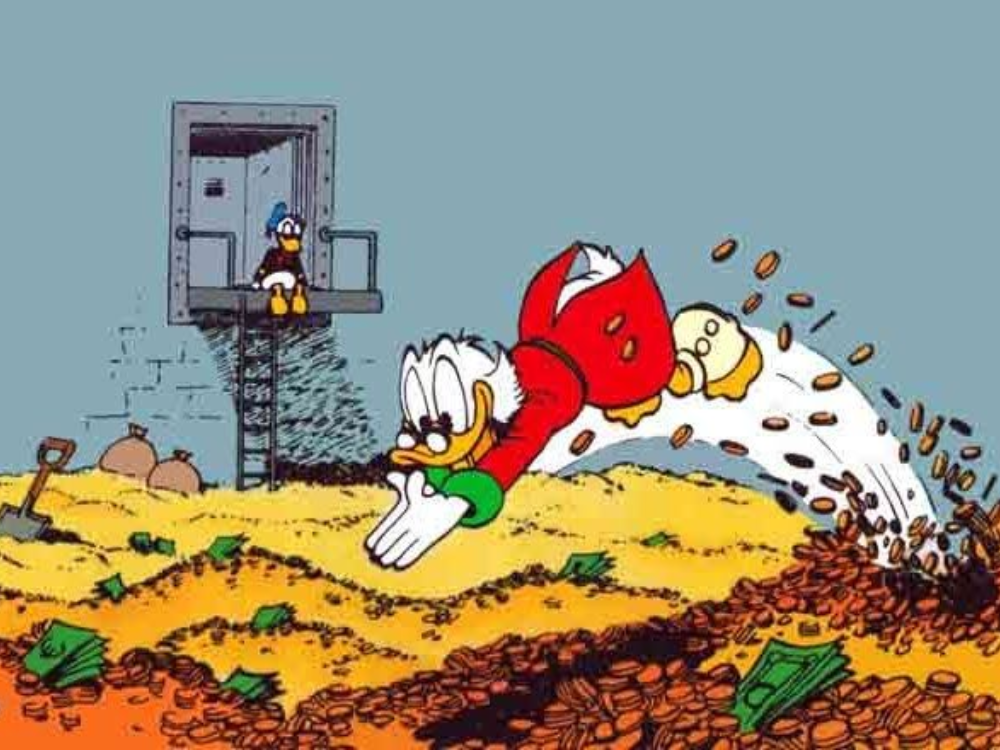 Scrooge McDuck, a Disney cartoon character, dives head first into a massive vault of gold and money.